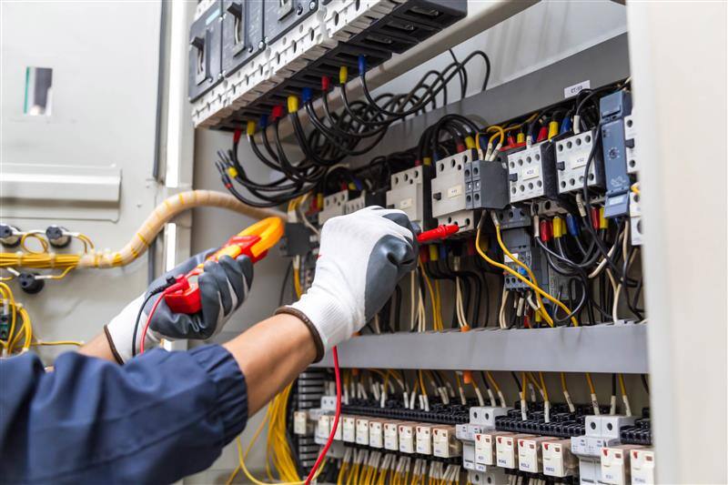 Electrician executing detailed fuse box diagnostics