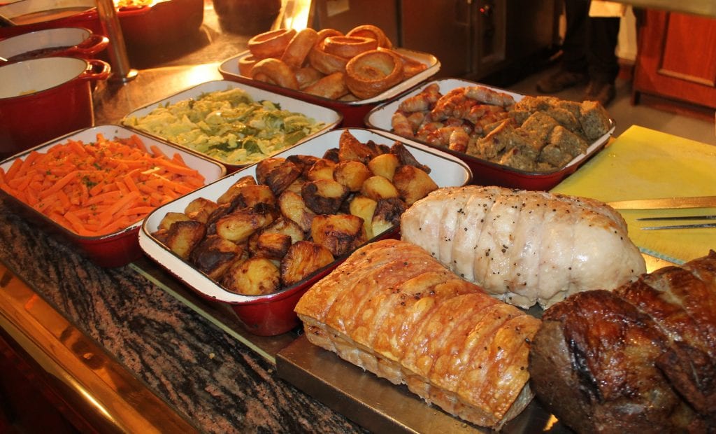 Family gathering for Sunday roast at a long pub table